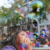 ProQR's Silvia Catellani blowing bubbles at Leiden Pride 2023